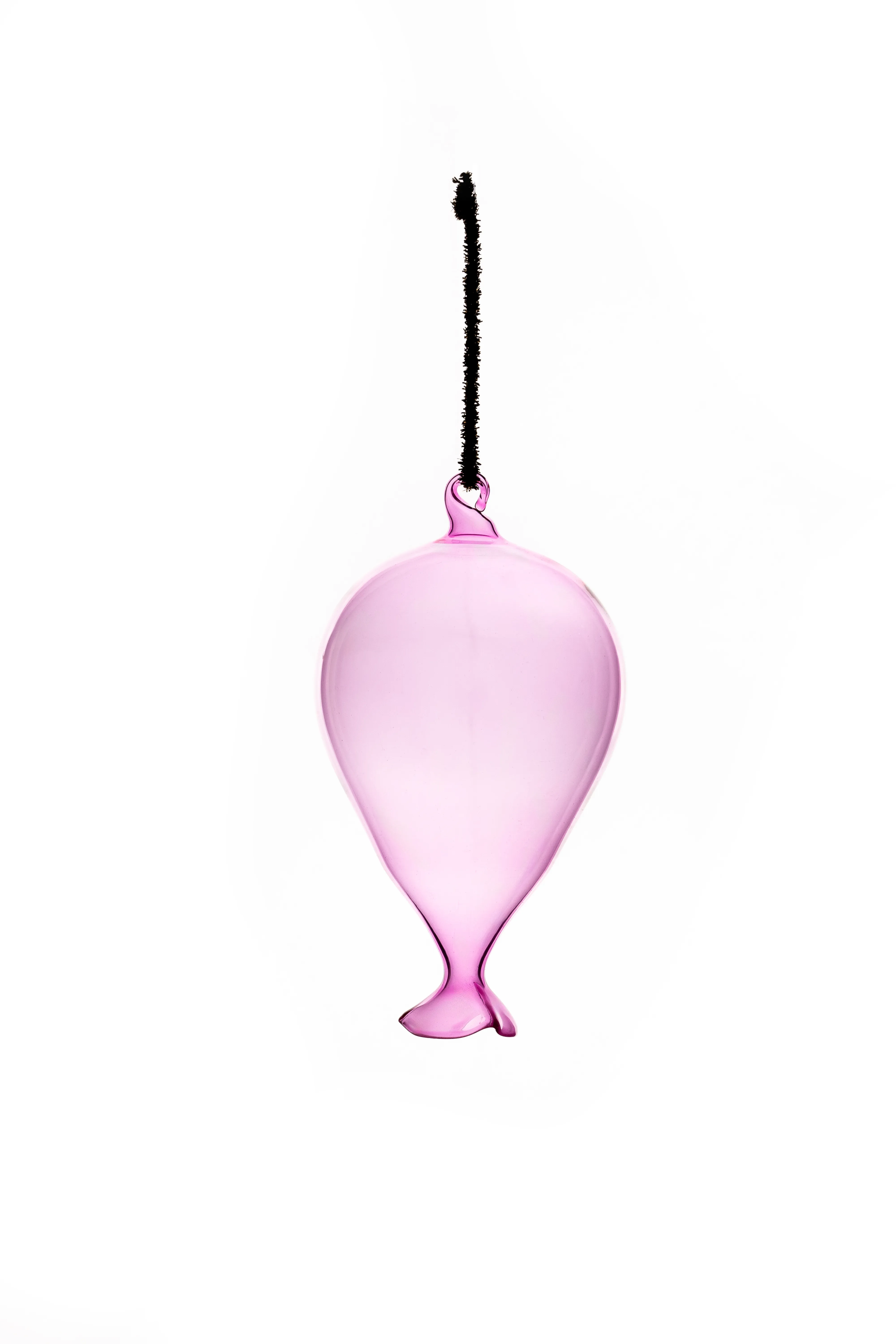 A pink glass balloon-shaped ornament on a black cord, hanging against a white background.