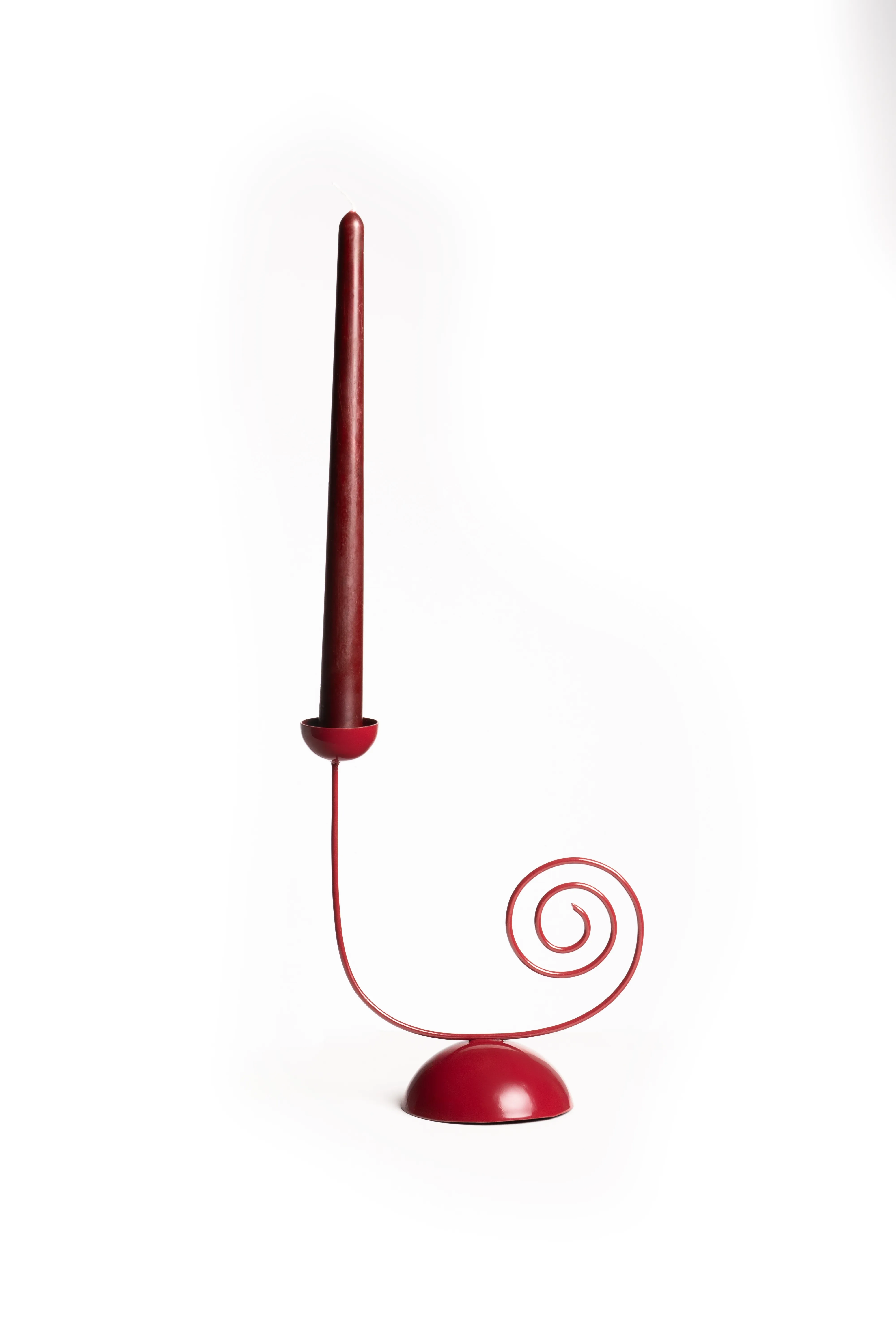 A red spiral-base single candle holder fitted with a taper candle, against a white background.