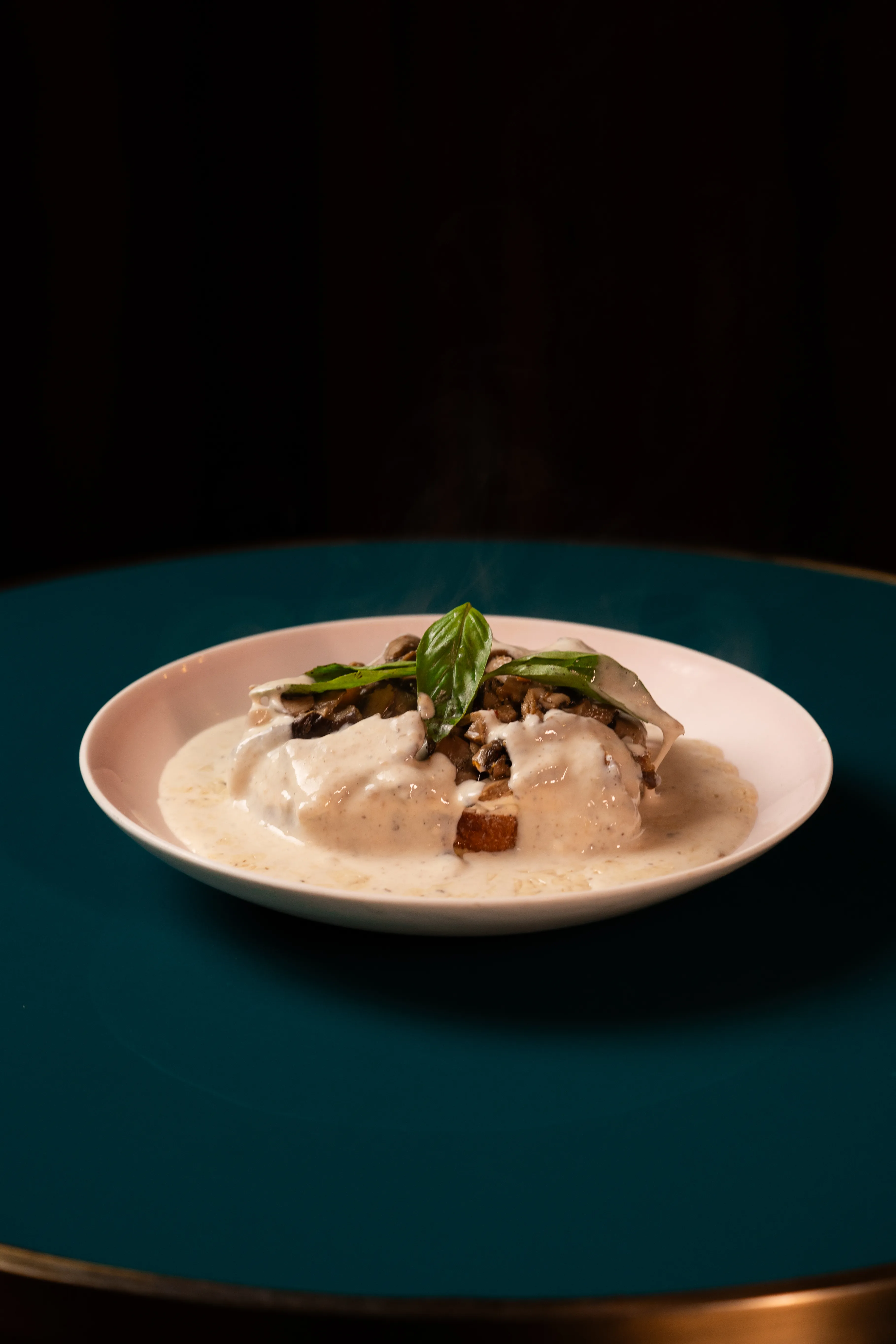 An overhead view of the mushroom toast dish with steam rising from the plate.