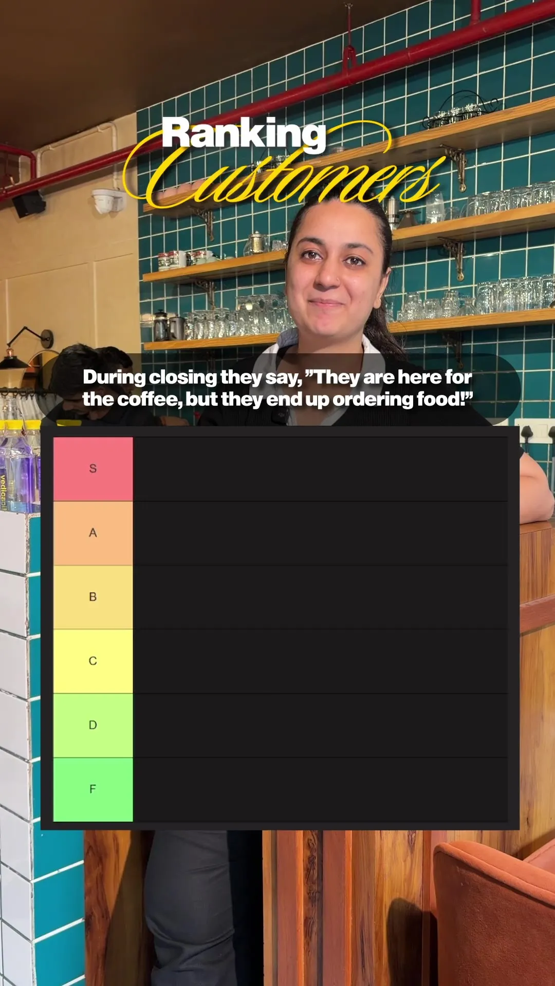 A staff member at the counter beside an on-screen graphic ranking customer complaints.