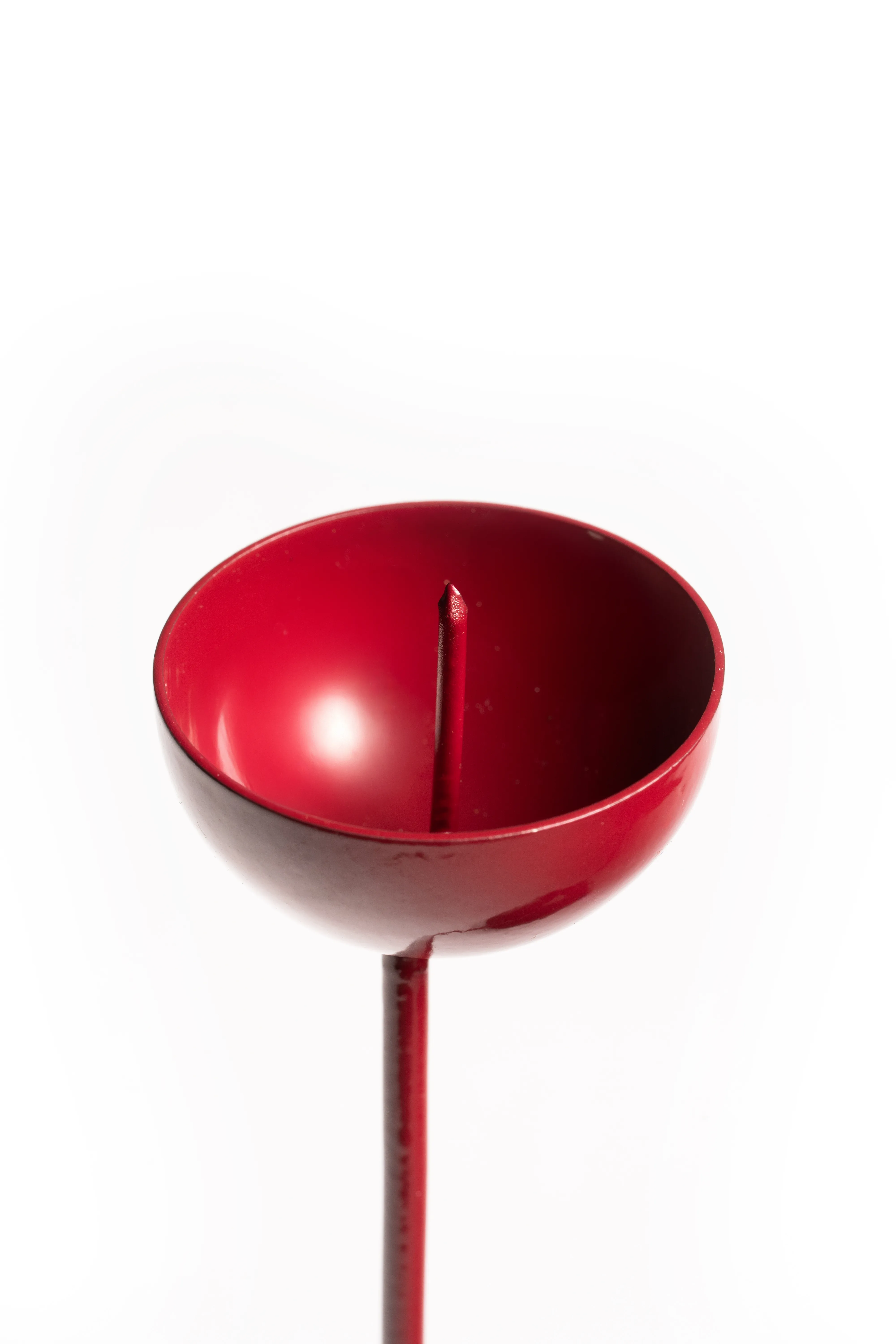 A close-up of the red spiral-base single candle holder's empty cup against a white background.